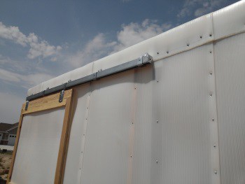 Greenhouse sliding barn door top rail